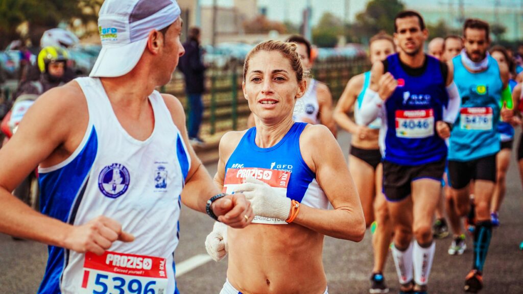 A group of marathon runners competing in an outdoor race, showing determination and energy.